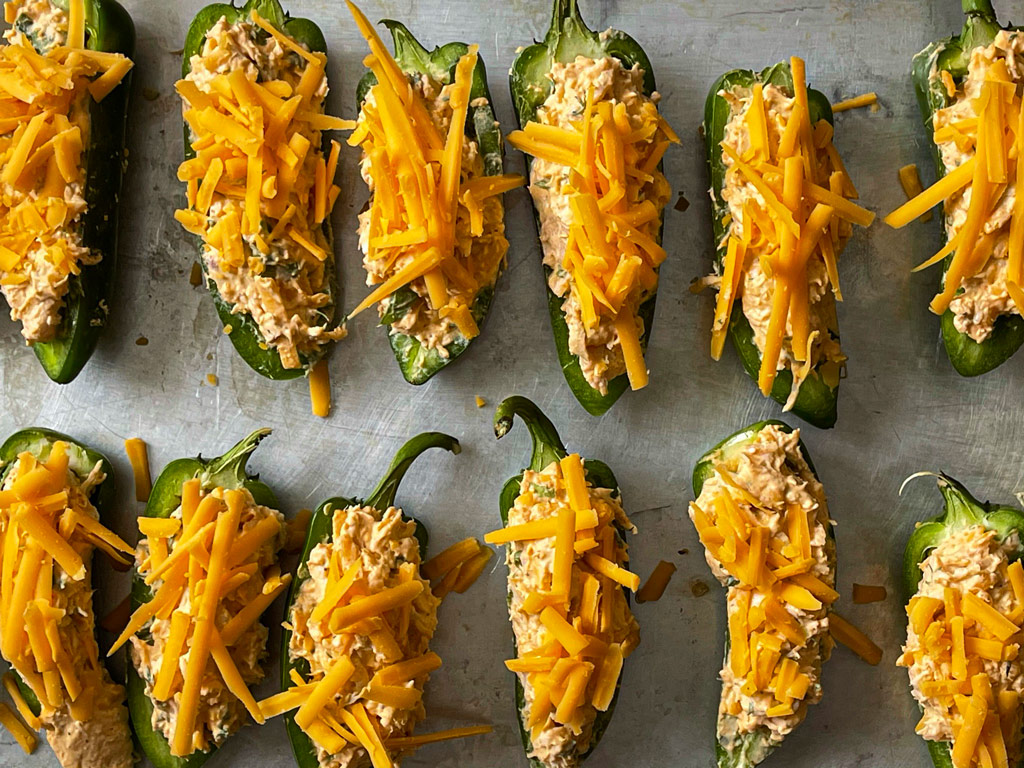 Stuffed Jalapeno topped with cheddar cheese before baking